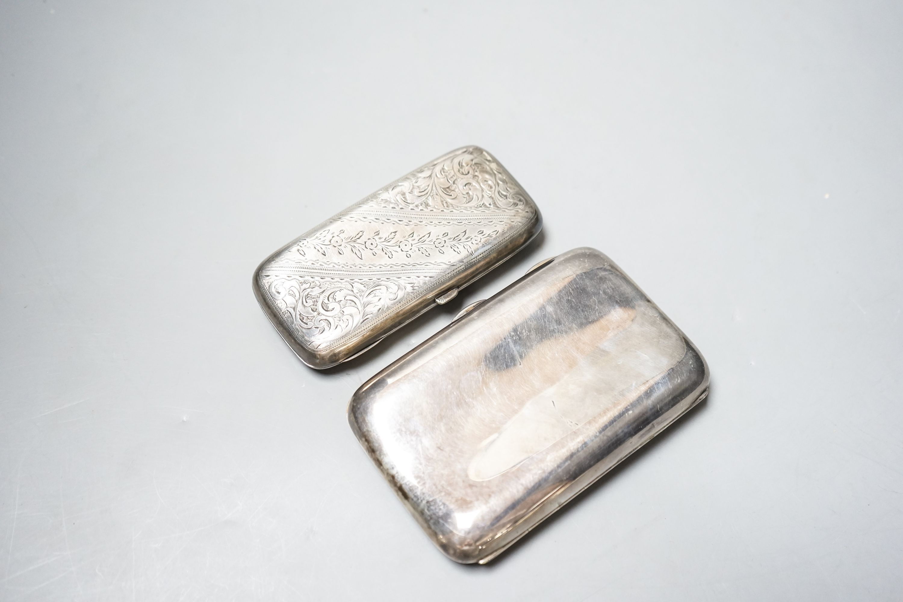 A late Victorian engraved silver cigar case, 13cm and a later silver cigar case, gross 11.5oz.